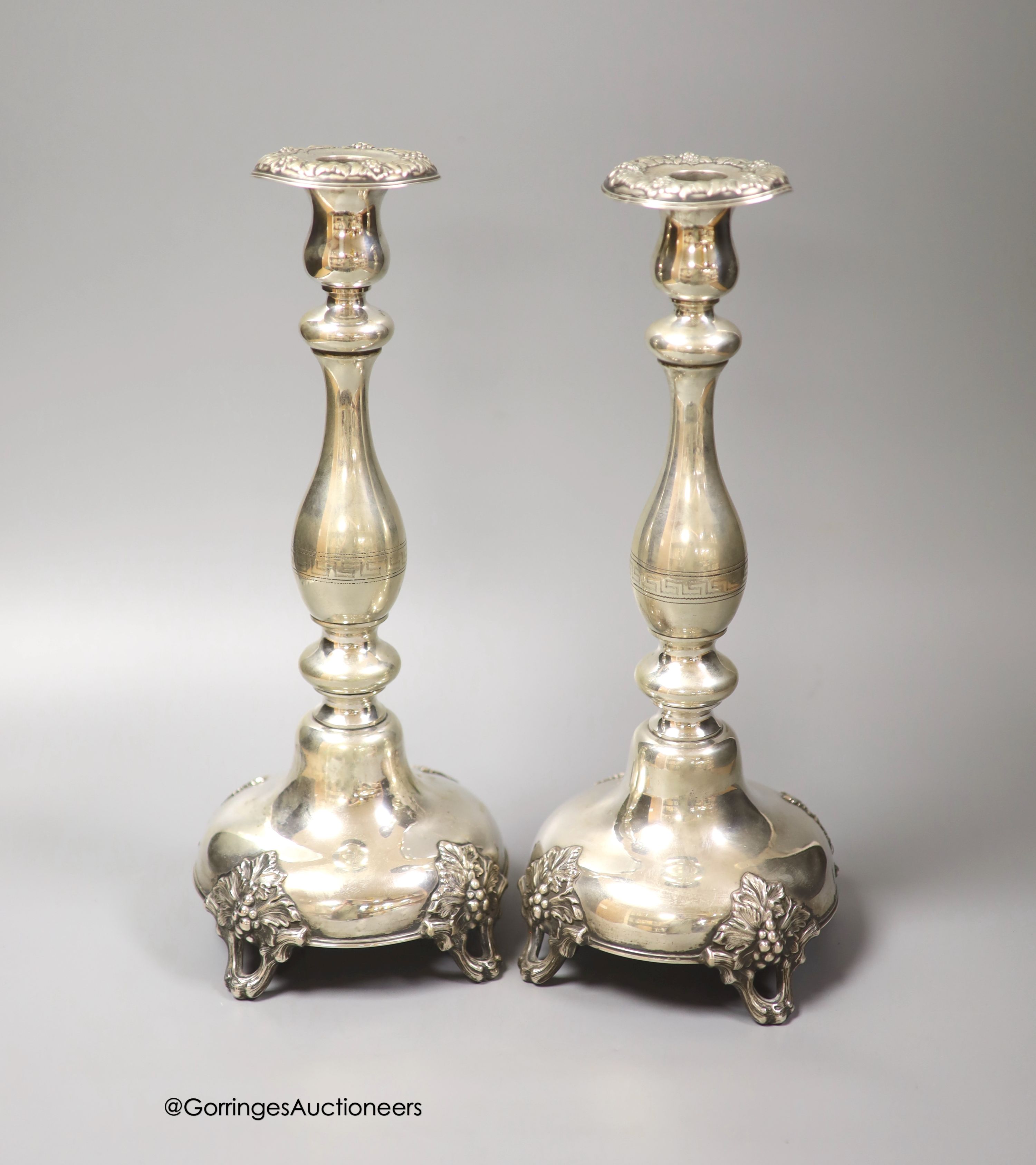 A pair of 19th century Polish? white metal candlesticks, 33.1cm, weighted